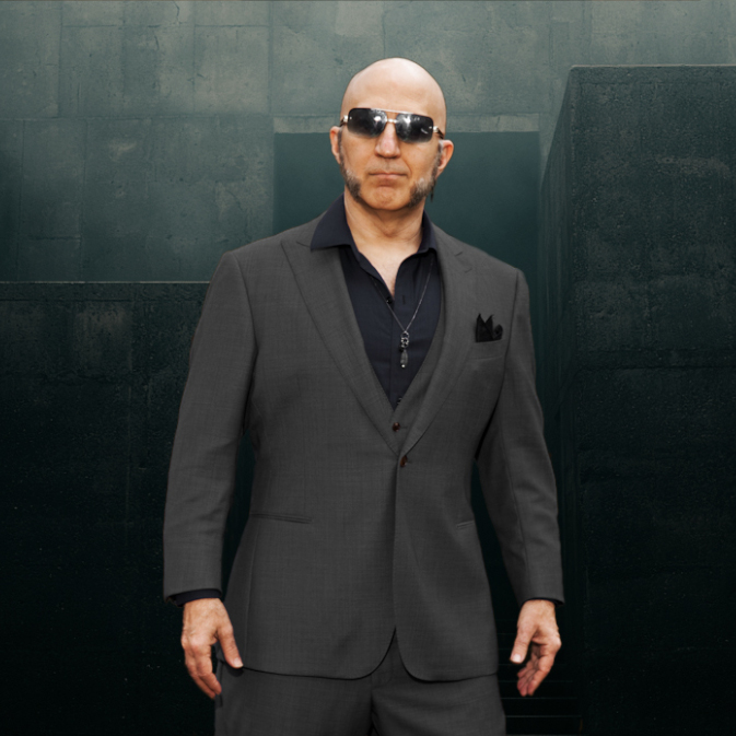 Dominant master - The Shadow Priest, brutalist background behind him