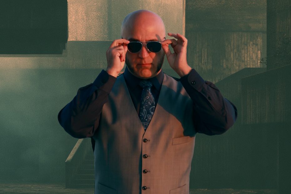 Shadow Priest puts on sunglasses in front of a brutalist background